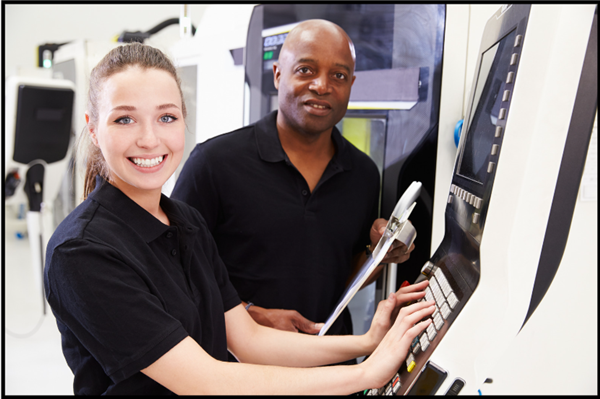 apprentice and employer working on a machine