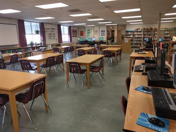 Desks, computers, and book shelves in the media center 