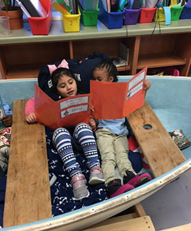 Kids in boat reading 