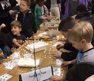 Students building toothpick towers 