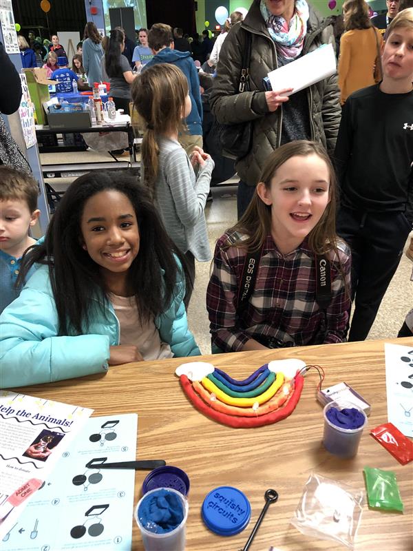 girls in art class smiling 