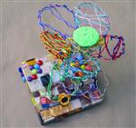 Wire sculpture of a flower on a mosaic base