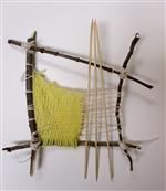 Yellow and white yarn weaving with found sticks