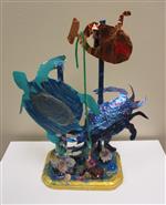 Tin sculptures of turtle and crab on a mosaic base