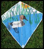 Kite painted with a duck floating amongst reeds
