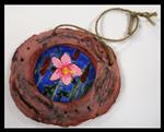 Mixed media medallion with pink flower in center