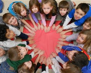Group of childrening forming a heart with their hands.
