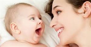Infant and parent smiling