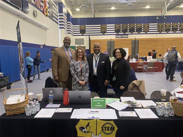 The administrative staff of Lindale Middle School posing in front of their table at a job fair. The administrative staff of Lindale Middle School posing in front of their table at a job fair.