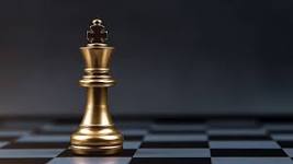 Single Chess piece on chess board - gold King