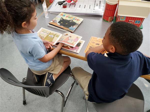 Students buddy reading together.