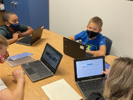 Students working together on the laptop
